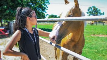 A UC Davis Pre-College student visits the Equestrian Center on campus