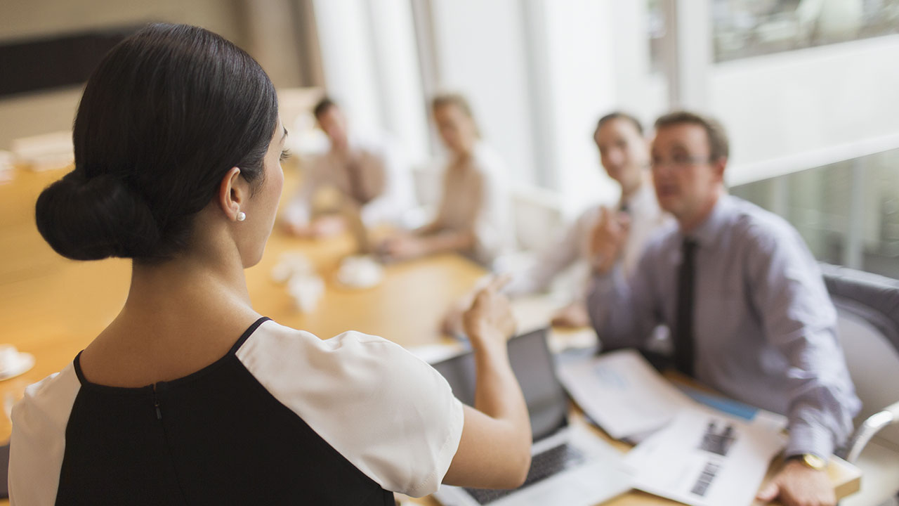 woman leading a meeting in conference room
