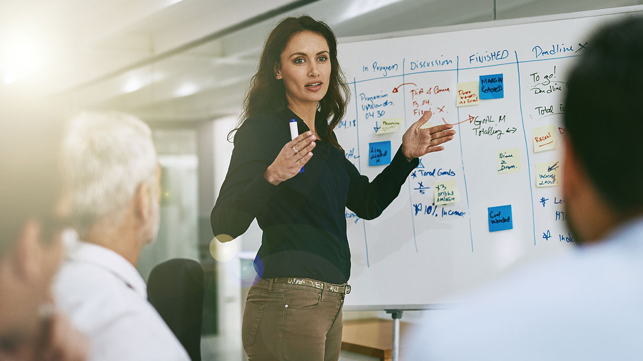 woman writing on whiteboard