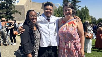 UC Davis health professions post-bac grad Andre Brown poses with program director and advisor