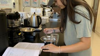 UC Davis Pre-College student following the coffee brewing process step by step