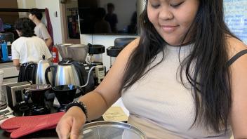 UC Davis Pre-College student sifts coffee beans