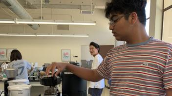 UC Davis Pre-College student gets ready to grind the beans
