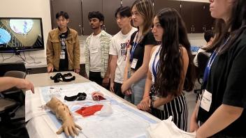 UC Davis Pre-College students receive instructions about suturing before using suture kits to get hands-on experience