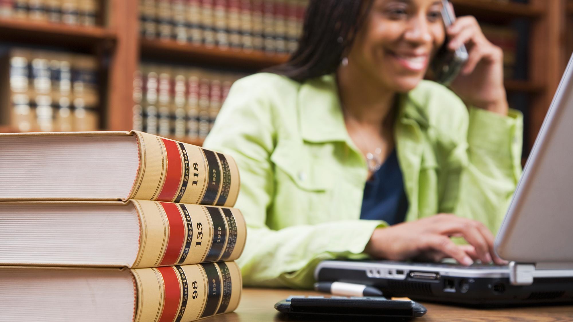 woman working on a laptop in a law office