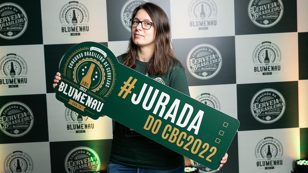 Lana poses at the Brazilian National Beer Competition with a sign