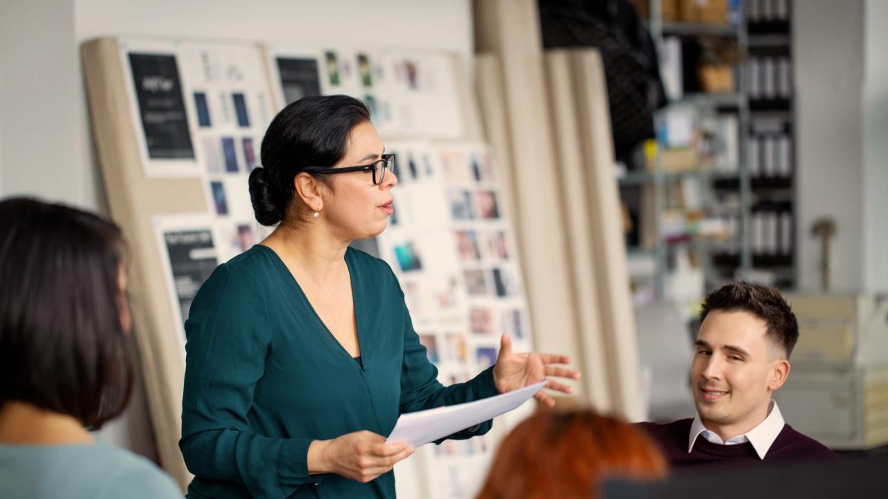 Coaching Professional talking in a meeting