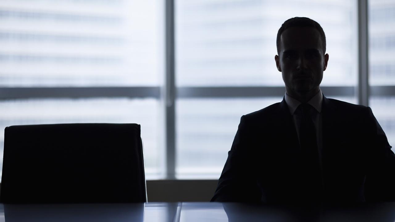 a person sits in a dark office alone