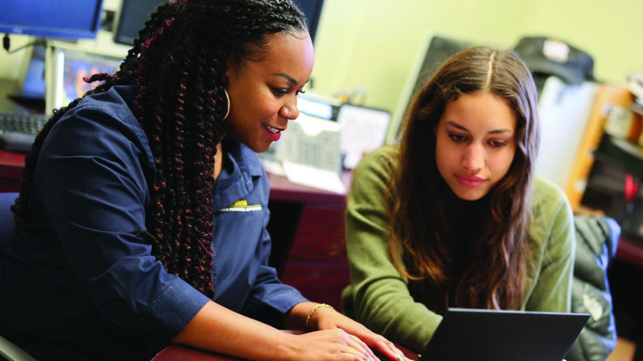 image of advisor working with student at desk with laptop