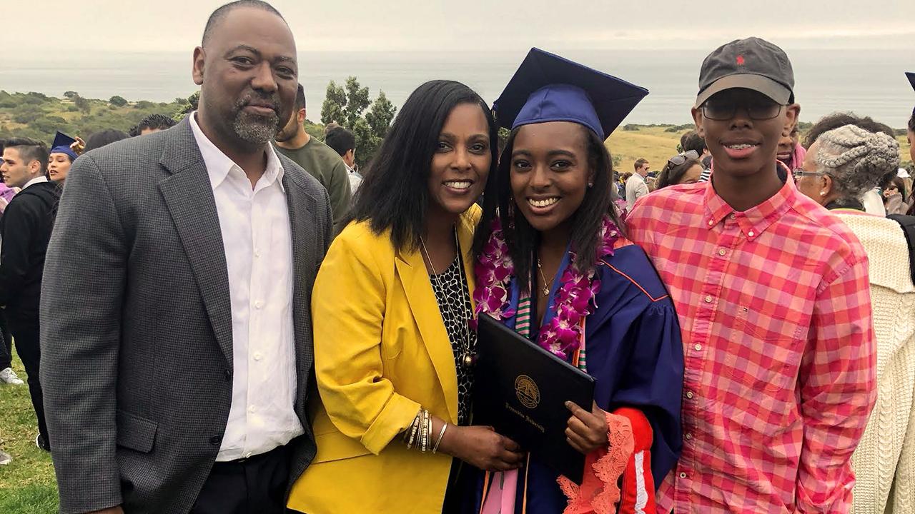 UC Davis health professions post-bac grad Kayla Hall with her family at her undergrad graduation