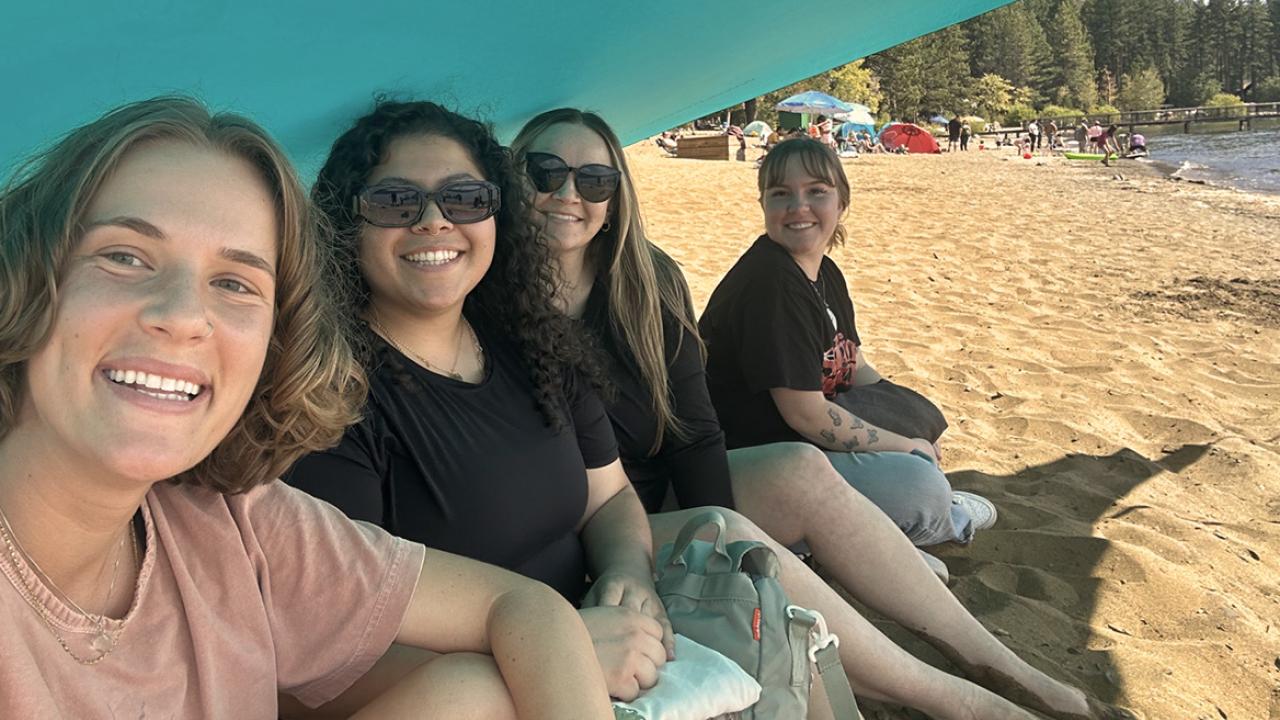 UC Davis health professions post bac grad Madison Dodds poses with friends from the program at the beach