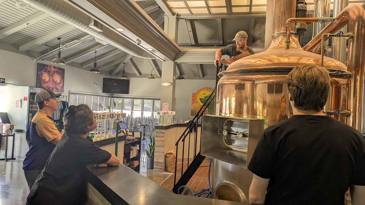 Master Brewers program students at the Sudwerk Brewery during brew day watch a demonstration