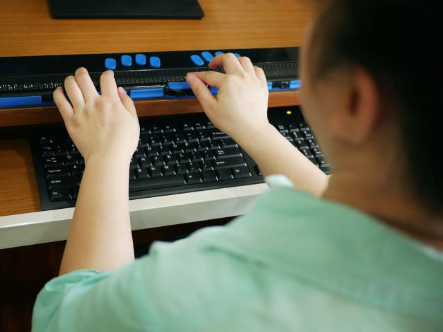 A person using an assistive device