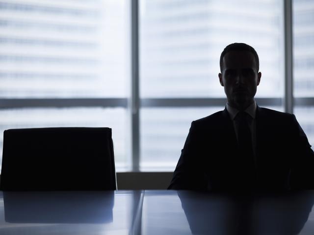 a person sits in a dark office alone