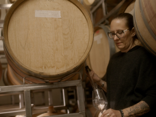 A person pouring a test-glass