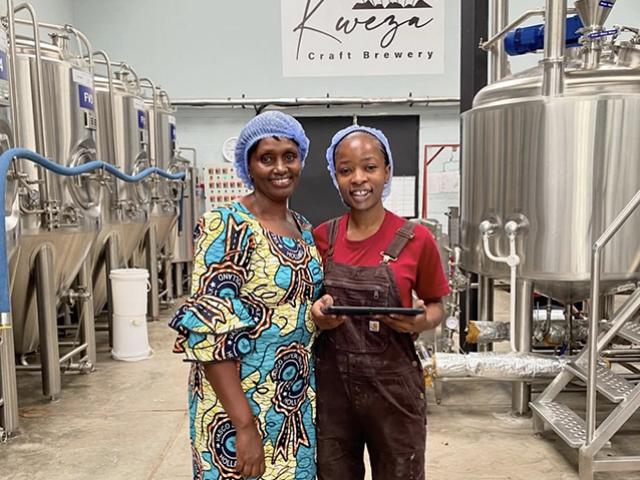 Tapiwa (right) poses with Josephine Uwase, a traditional sorghum maltster at Kweza