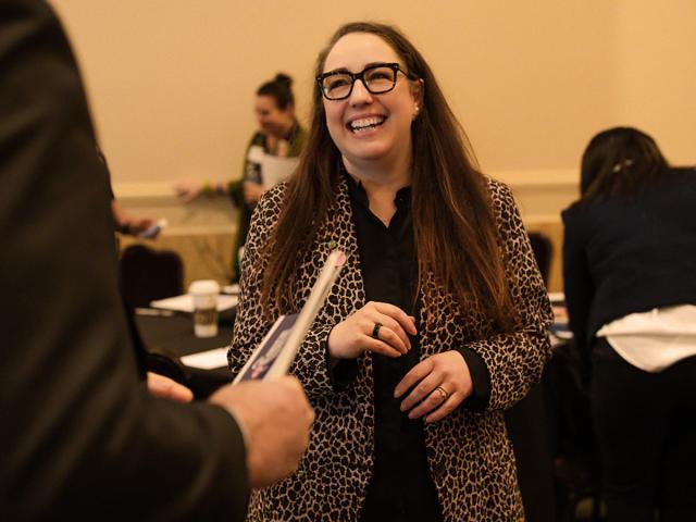 UC Davis Davis Executive Leadership Program graduate Lacey Felder smiles at someone in the foreground