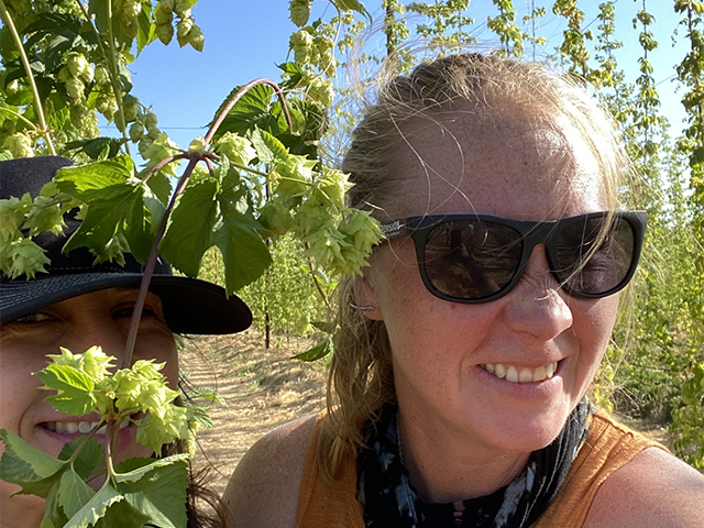Lauren Price poses next to hops
