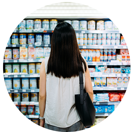 woman looking at items on a shelf in a supermarket