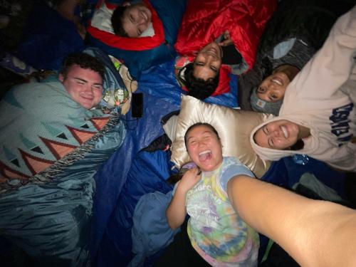 Camp counselors holding hands in a circle