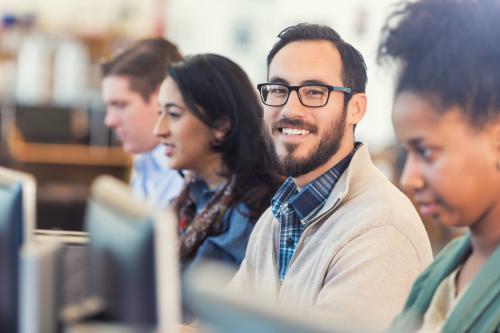 Students in class, engaged, with one smiling