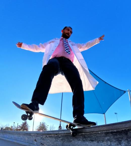 Dr. Patel skateboarding in his white coat