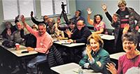 OLLI members waving in classroom
