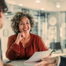 a financial advisors speaks with two clients