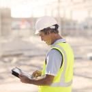 an architect using digital tablet at construction site 
