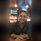 Rajesh, CPE project management student, smiles for the camera in a bar