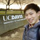 Ryotaro Okada next to the UC Davis sign