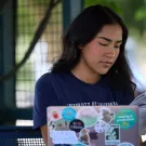 UC Davis student looking at her laptop outside