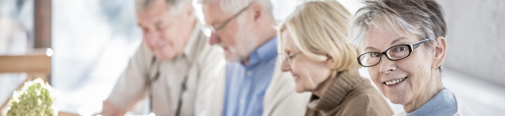 group of older people working on their phones and tablets
