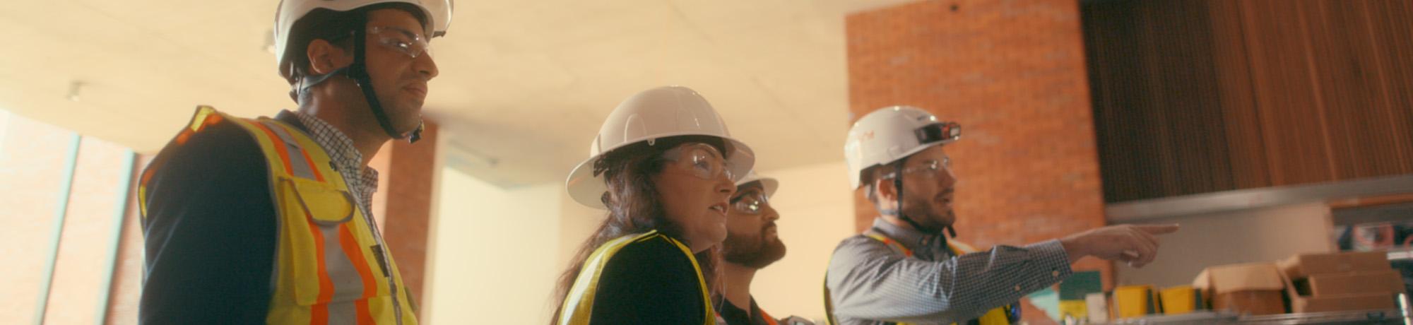 a group of construction professionals looking in a building