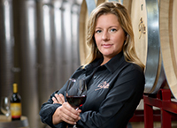 Winemaking Certificate grad Amy LaBelle with wine in her winery