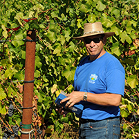 Winemaking Certificate grad Pedro Vargas outside in vineyard