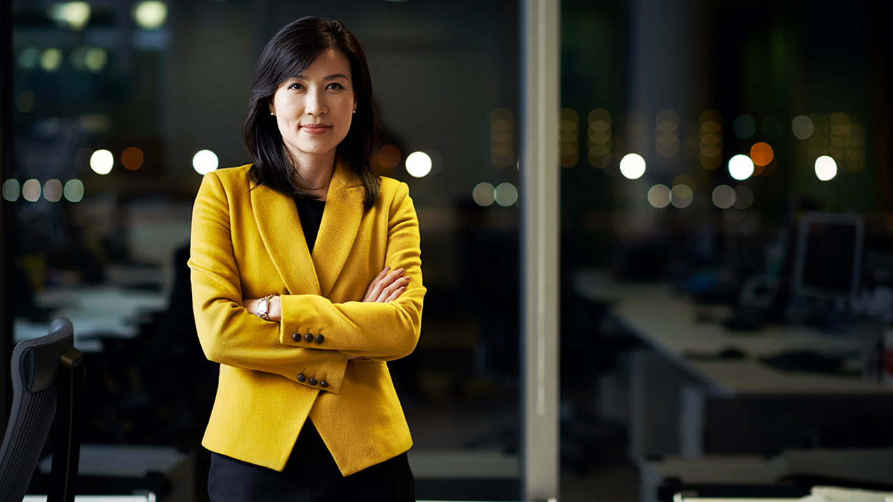 woman in business suit smiling at camera