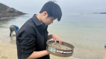 UC Davis Pre-College student examines sand collected at the Bodega Reserve