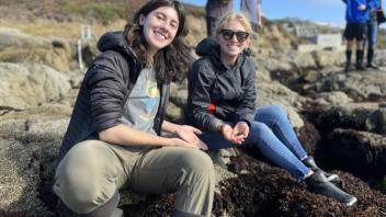 A UC Davis Pre-College student and TA show off the hermit crab found in the intertidal rocky zone