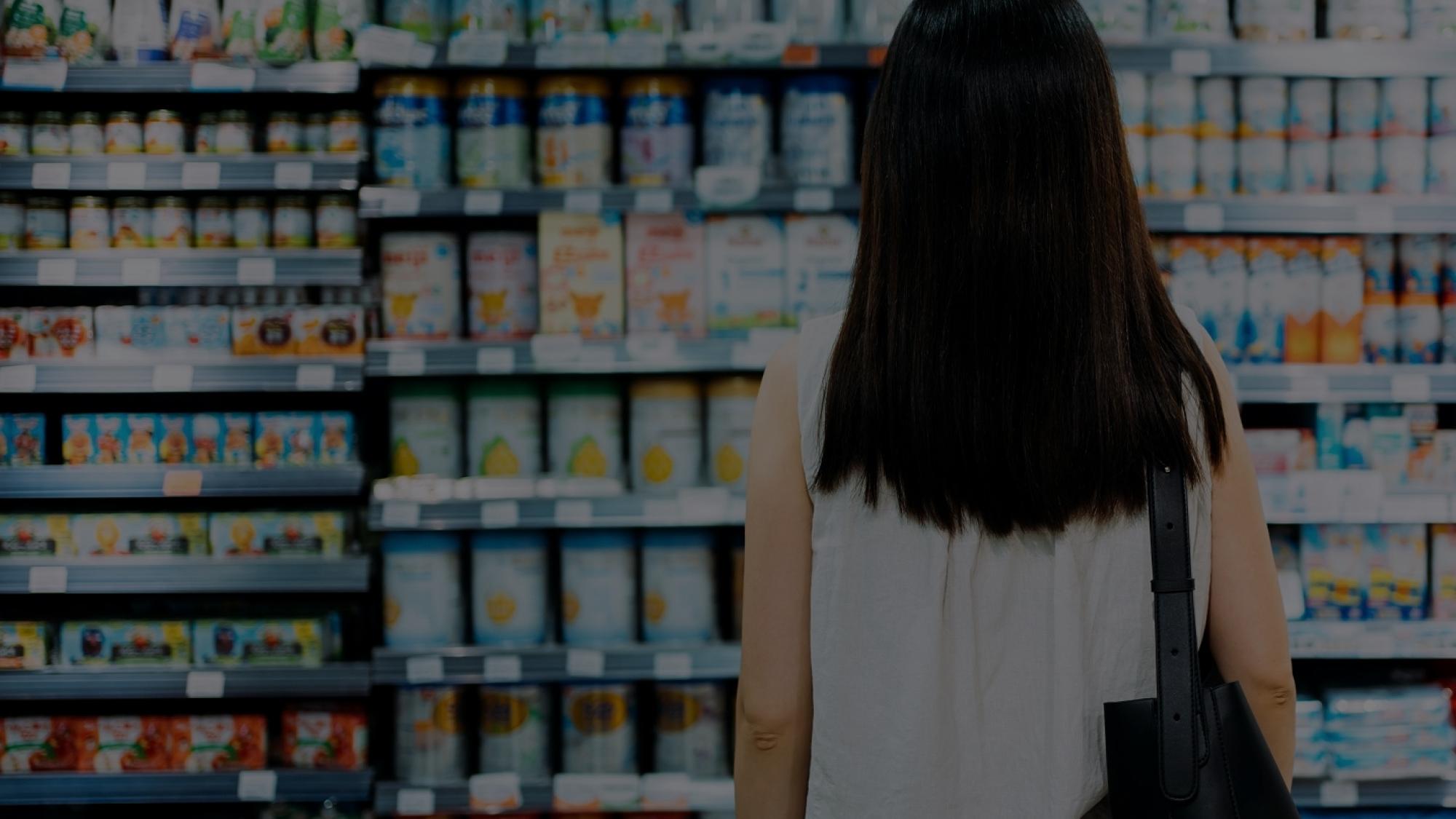 Woman looking a grocery shelves