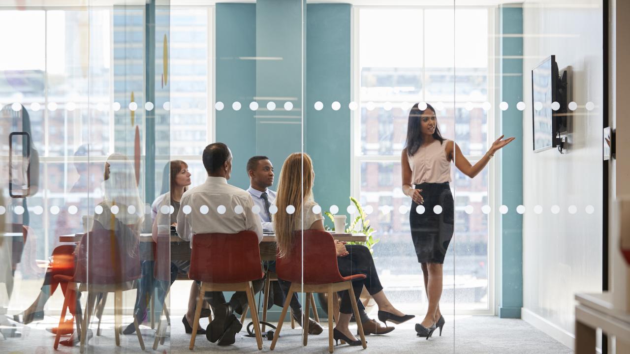 Woman pointing at whiteboard