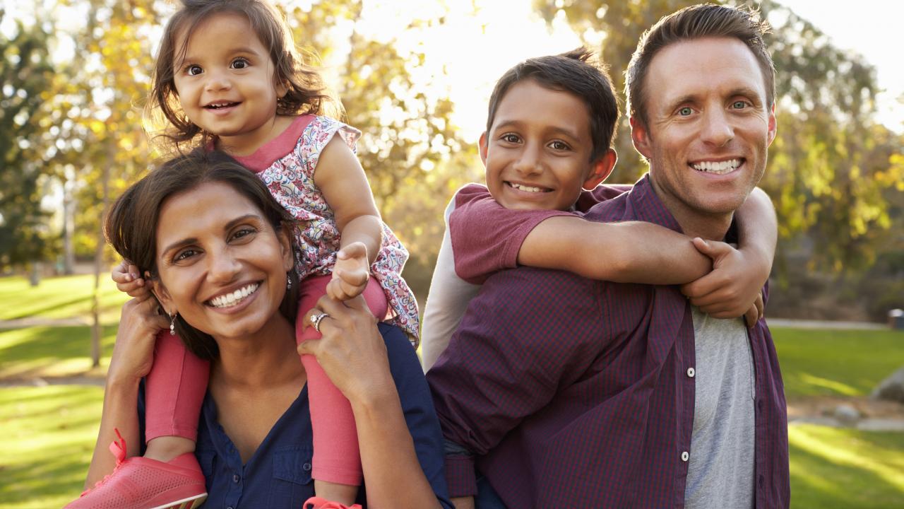 family posing in a park