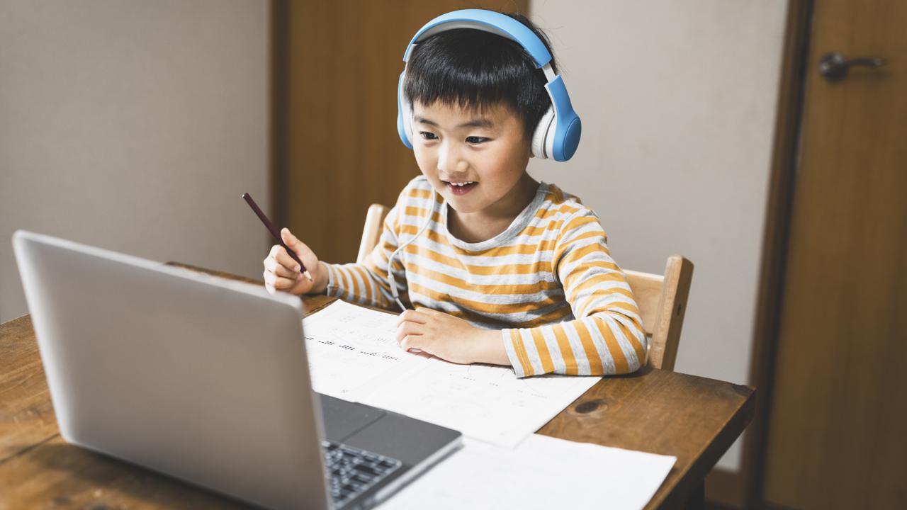 boy wearing headphones at computer