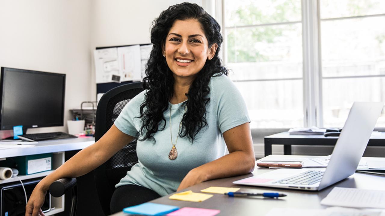 smiling woman at her desk