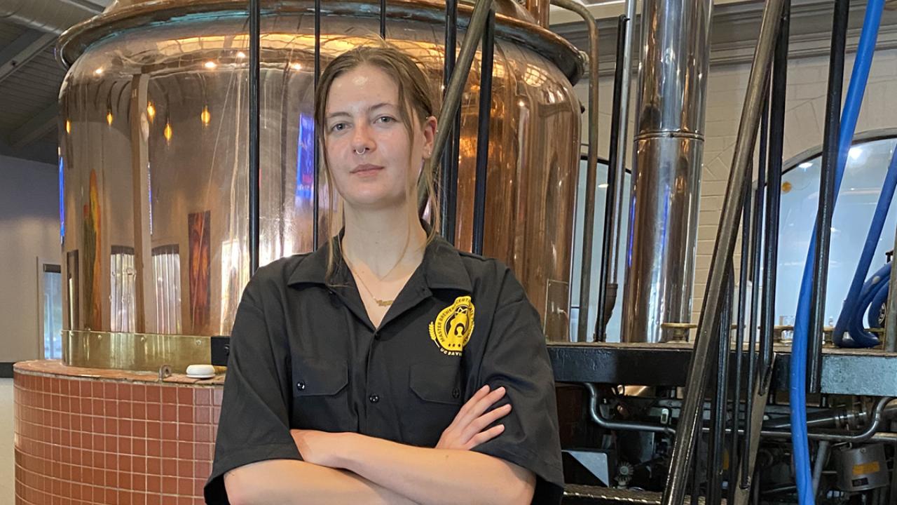 Master Brewer grad Ava Kemper poses in Sudwerk Brewing Company's brewer