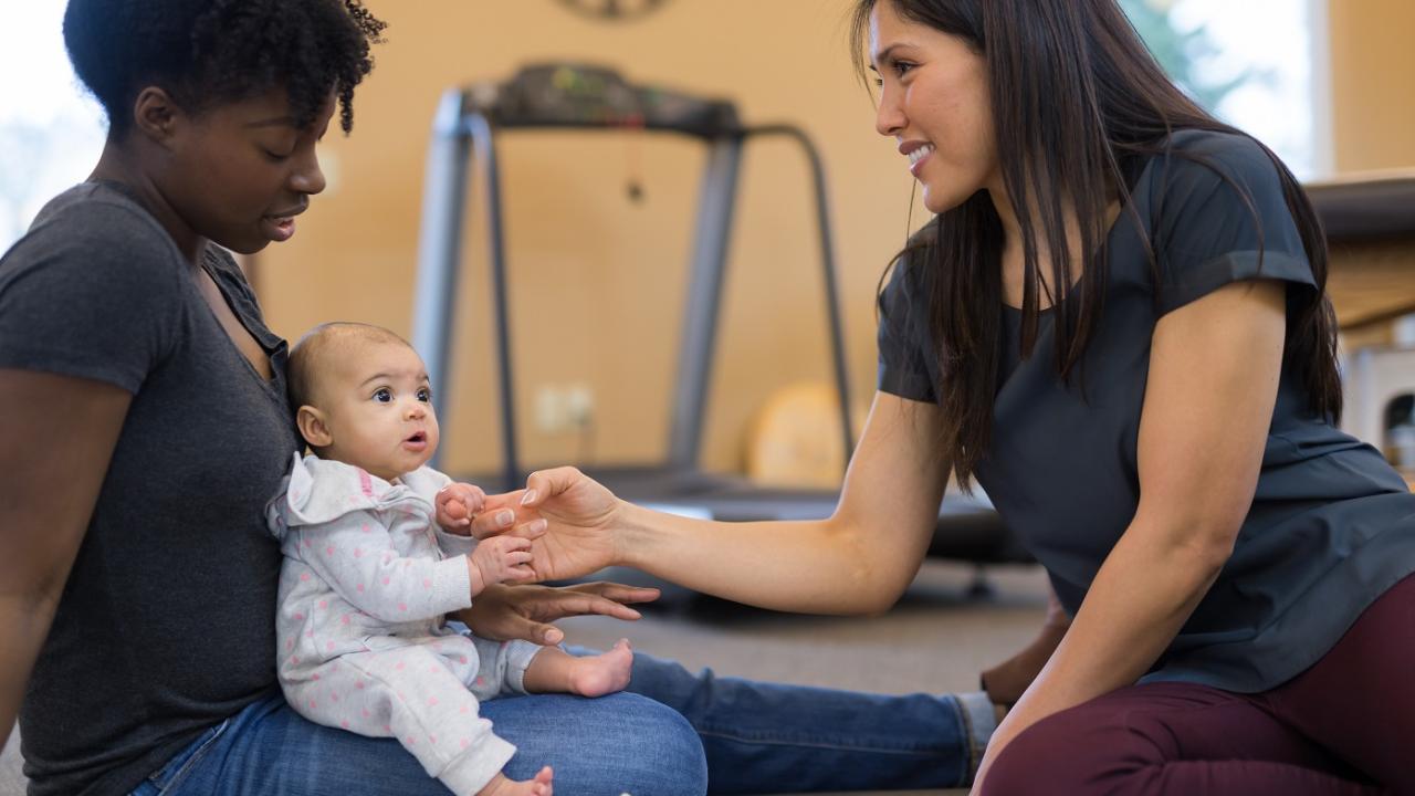 Mother, child, and instructor in a work-room