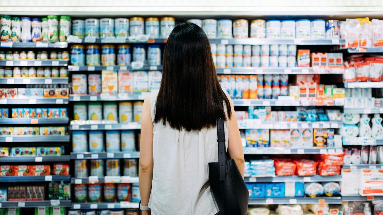 woman shopper looking at wall of products