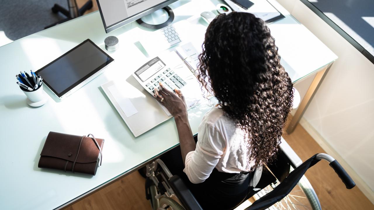 Person in wheelchair working at a desk