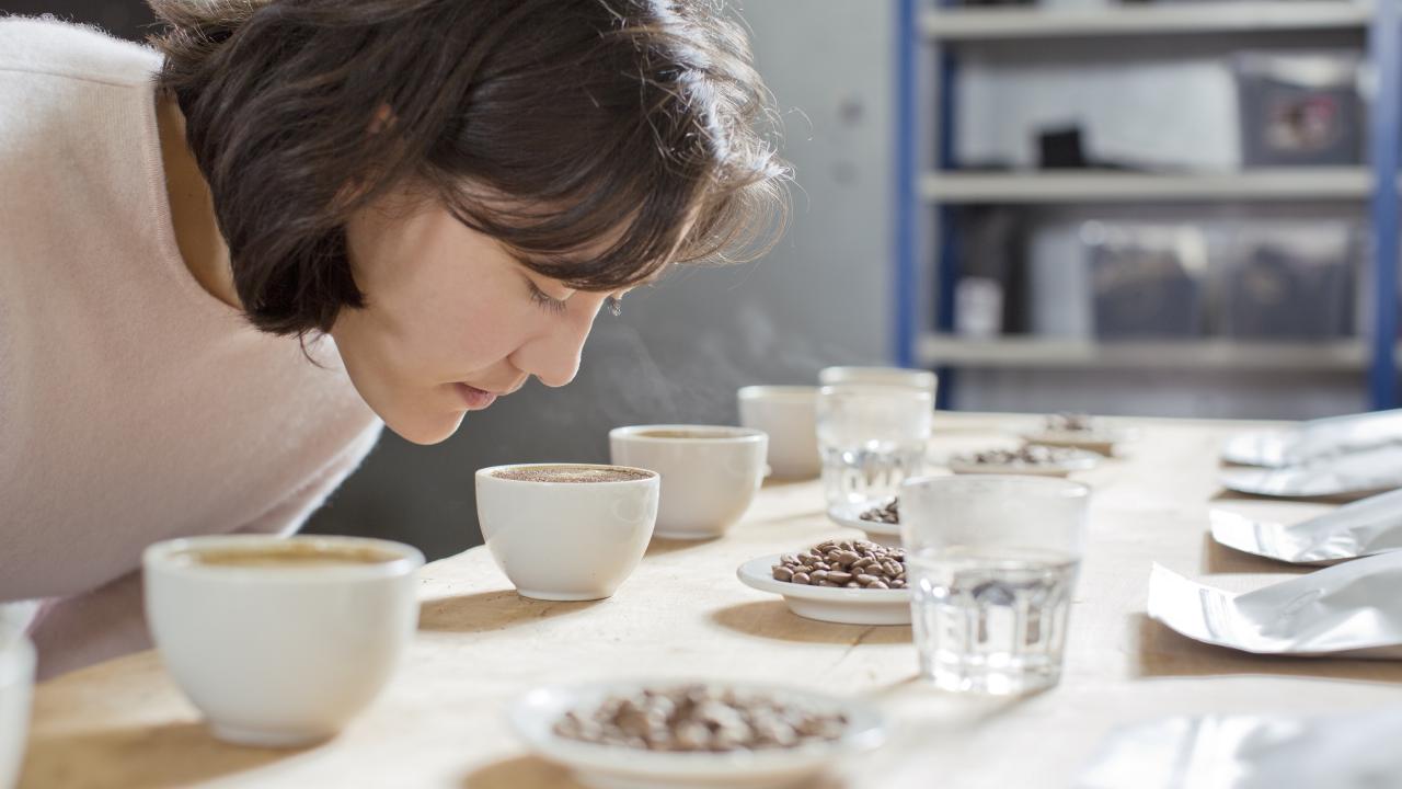Woman Smelling different samples of drinks