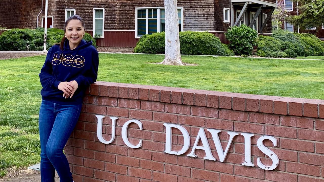 maternal and child nutrition master's student, Stefany Cinco, poses in front of UC Davis sign